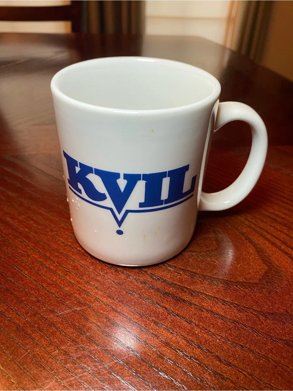 White Ceramic Coffee Mug with Blue KVIL Radio Logo. 10 Oz